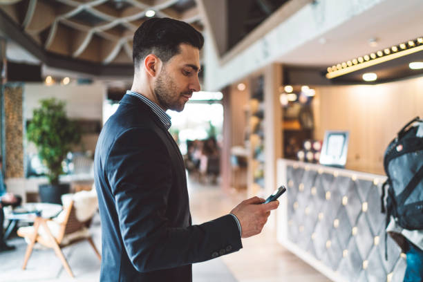 istock A young businessman in a suit using a mobile phone in a hotel lobby 1160187871
