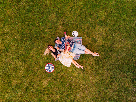 Aerial View Happy Best Friends Lying on the Grass