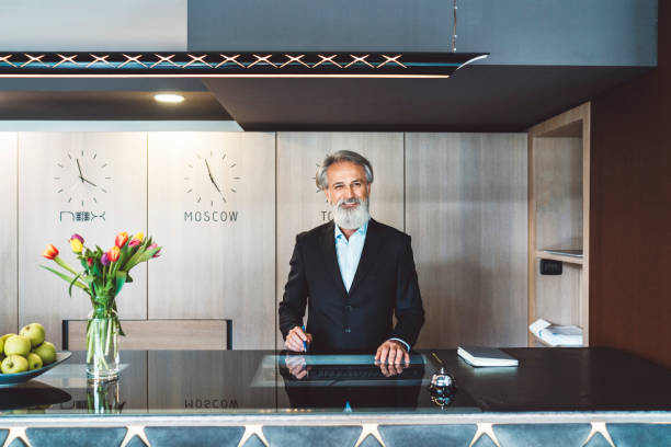 istock Old hotel receptionist welcoming guests 1160188926
