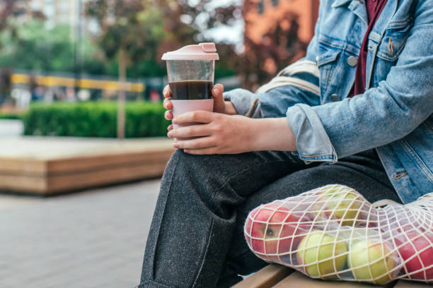 istock Young woman with eco-friendly reusable coffee cup and cotton bag, zero waste concept 1160189086