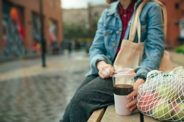 istock Young woman with eco-friendly reusable coffee cup and cotton bag, zero waste concept 1160189089