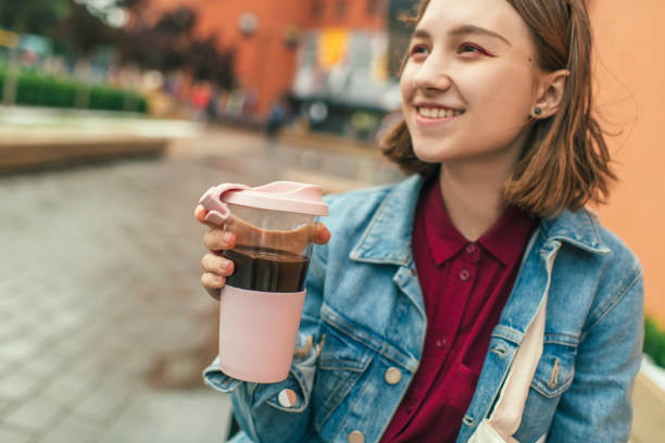 istock Young woman with eco-friendly reusable coffee cup and cotton bag, zero waste concept 1160189130