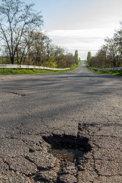 istock there are many potholes on the roadway close up 1160190551