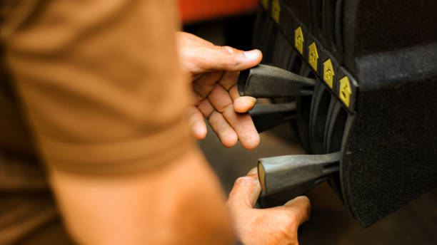 istock Technician's hand is controlling the lifting crane on the car. 1160191544