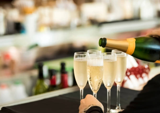 istock Waitress pouring champagne in the glasses 1160193275