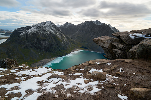 View from above over a beautiful beach and snowcapped mountains on Lofoten Islands in Norway.