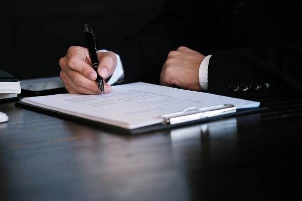 istock Businessman analyzing investment charts and pressing calculator buttons over documents. Accounting Concept. 1160196364