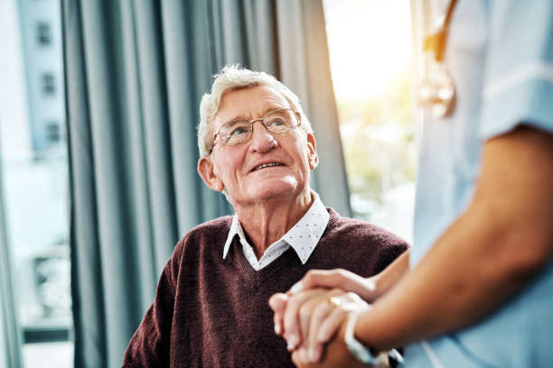 Thank you for showing me that you care Cropped shot of a nurse holding hands with a senior patient senior men stock pictures, royalty-free photos & images
