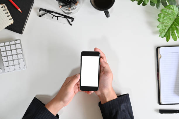 istock Top view businessman hands using mockup smart phone on office desk. 1160197740