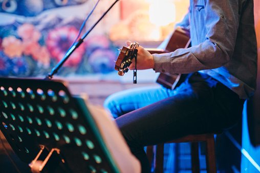 Guitar player in a café playing his music.