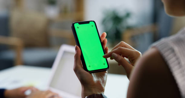 Stay in the loop with mobile technology Closeup shot of an unrecognisable businesswoman using a cellphone with a green screen in an office chroma key stock pictures, royalty-free photos & images