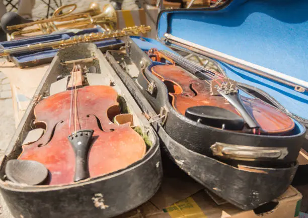 Photo of Old violin instrumen on market place.