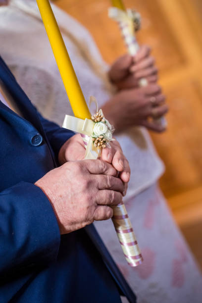 istock Old man hands holding candle during wedding ceremony in orthodox church 1160200717