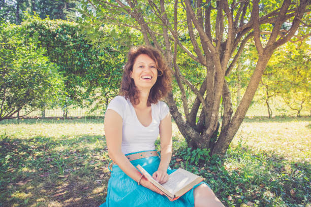 Outdoors Portrait of a mid adult woman with curly brown hair.