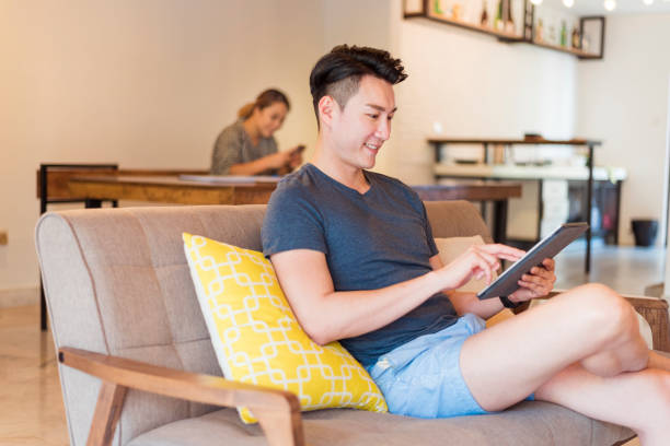 istock Young Asian couple using wifi technology at home 1160205668