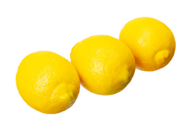 Row of three ripe yellow lemons isolated on white background