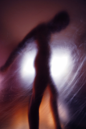 silhouette of naked male model behind nylon foreground. blurry&grunge look