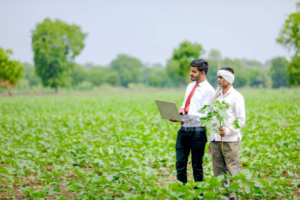 istock indian agronomist with farmer at field 1160214270