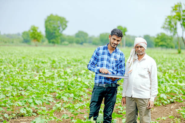 istock indian agronomist with farmer at field 1160214315