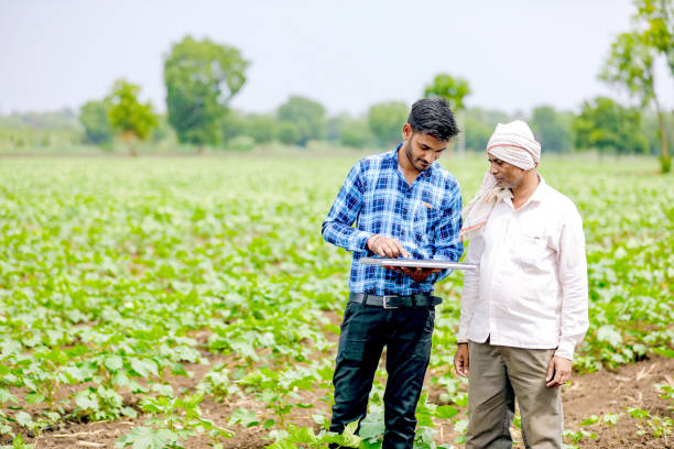 istock indian agronomist with farmer at field 1160214457