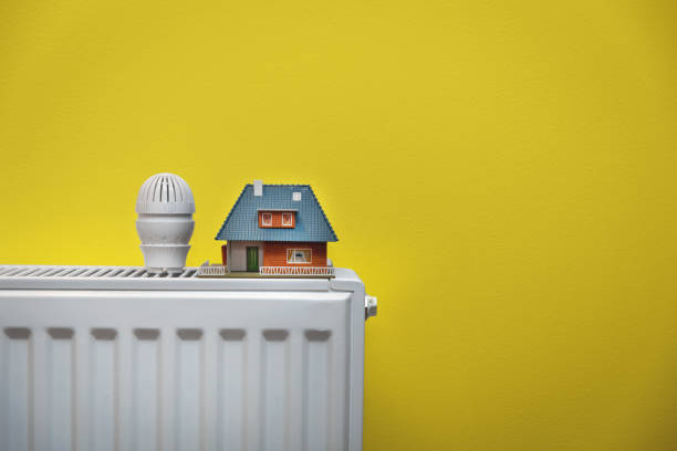 istock house heating system - white radiator on yellow wall copy space 1160214505