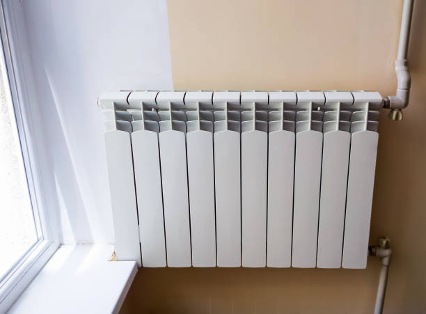 istock White metal heating radiator on the wall. Selective focus. 1160214716