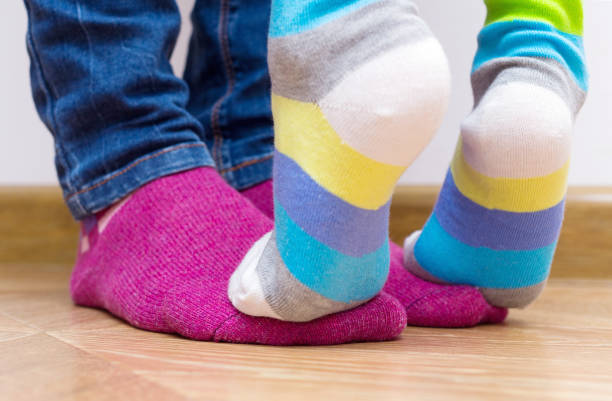istock Legs in bright socks. Part of body, selective focus. 1160214819