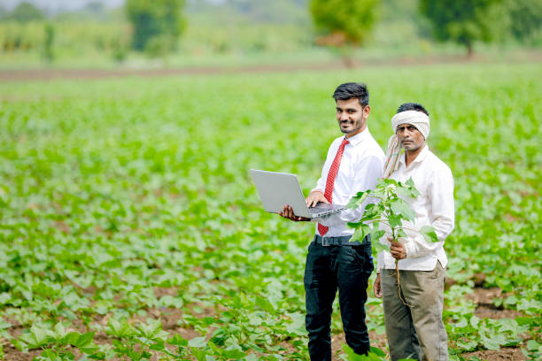 istock indian agronomist with farmer at field 1160215694