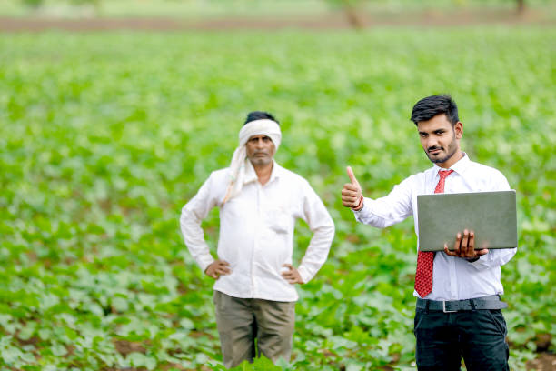 istock indian agronomist with farmer at field 1160215913