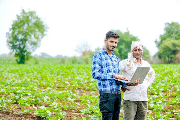 istock indian agronomist with farmer at field 1160216786