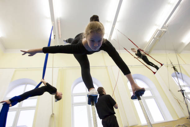 gymnastic training for children. girl to study circus art - small gymnastics athlete action imagens e fotografias de stock