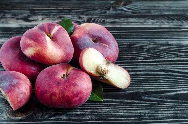 istock flat peaches on dark wooden background Fig peaches 1160217904