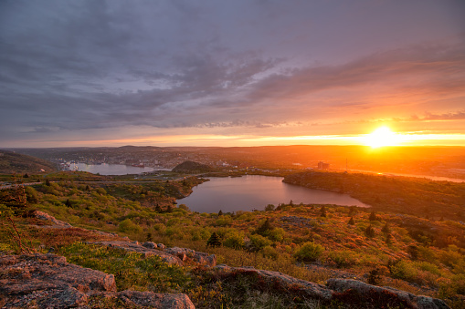 Beautiful golden light shining on the the hillside overlooking the city of St Johns.