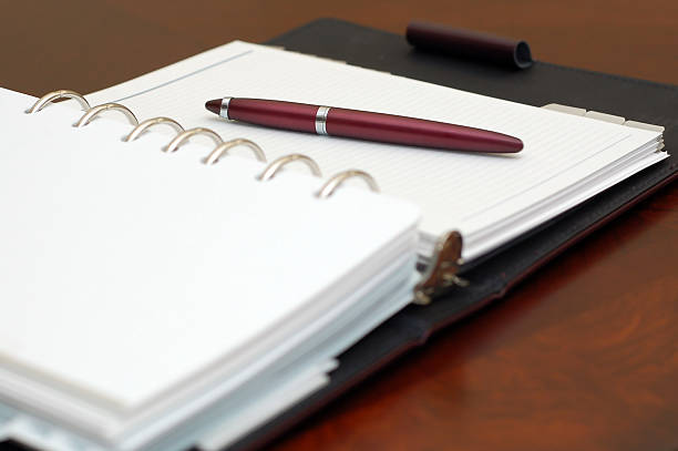 istock Personal Organizer Day Planner and Red Pen on a Desk 116022116