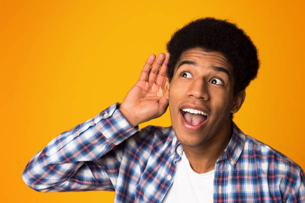 istock Interested guy trying to hear information, holding hand near ear 1160221182