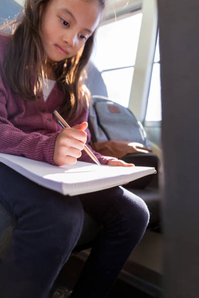 istock Confident girl studies on school bus 1160223216