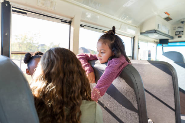 istock Girls chatting on school bus 1160223226