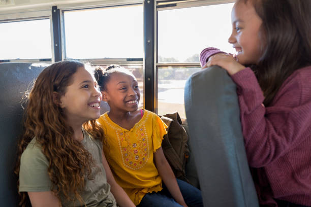 istock Cheerful elementary school friends on bus 1160223230