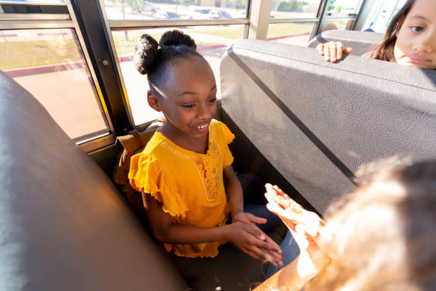 istock Girls play clapping game on bus 1160223233