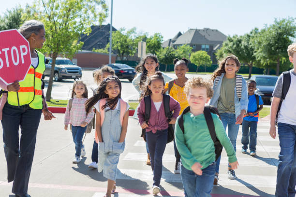 istock Excited schoolchildren cross crosswalk 1160223247