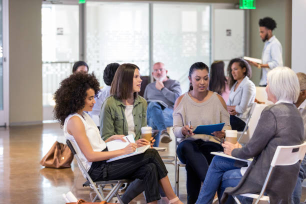 istock Group of women participate in group therapy session 1160223310