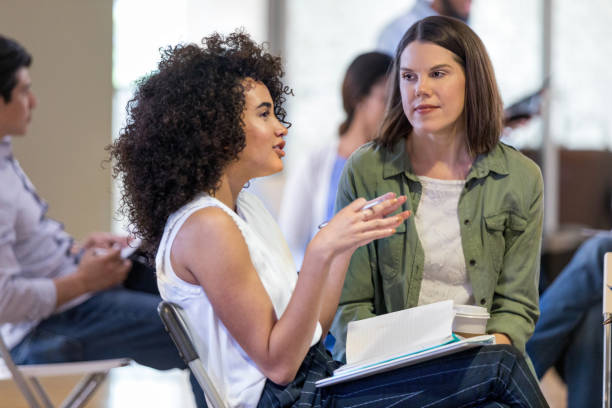 istock Young woman gesturing during HOA meeting 1160223312