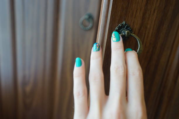 istock Female hand with a beautiful manicure opens the wardrobe door 1160223335