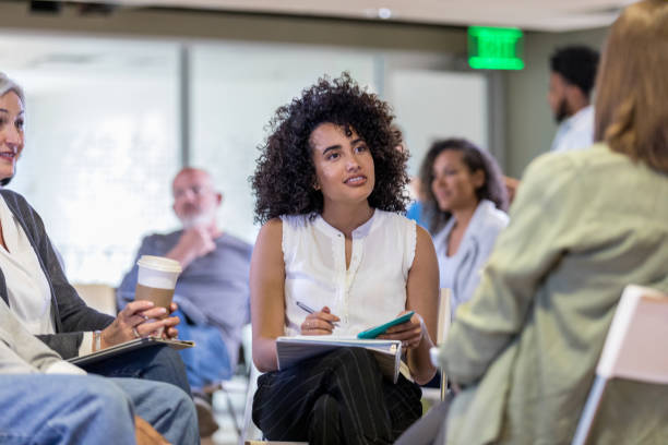 istock Attentive therapist listens to woman during support group meeting 1160223349