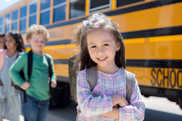 istock Elementary student crosses arms while waiting to board bus 1160223435