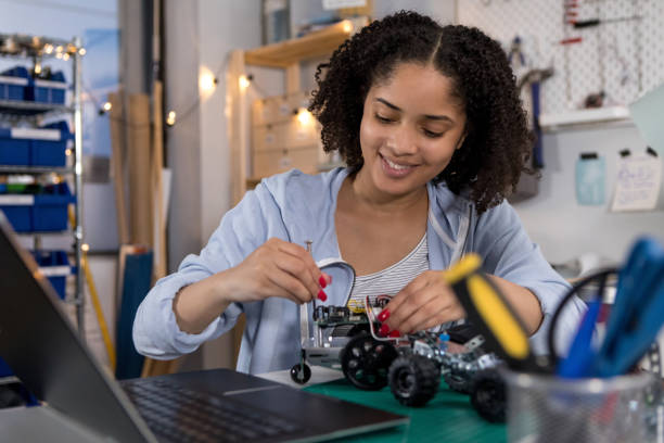 istock Cheerful teenager assembling a robot 1160223592