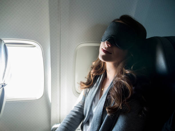 istock With sleep mask on, woman gets deep sleep during flight 1160223608