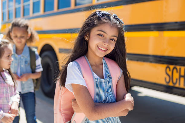 istock Elementary girl looks at camera and crosses arms while waiting 1160223662
