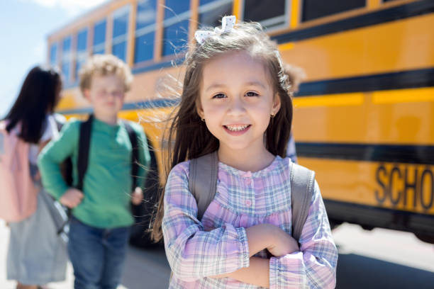 istock Elementary student crosses arms and waits to board bus 1160223697
