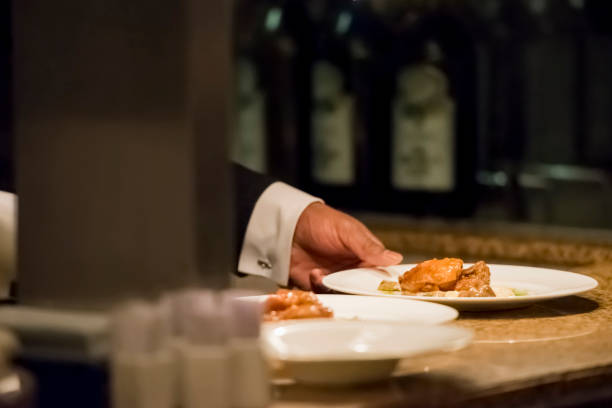istock Waiter in suit serving food 1160224931